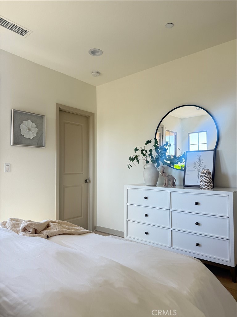 87 Evening Sun Irvine, CA 92620 - Photo 17 of 29 a bed room with a bed and a dresser