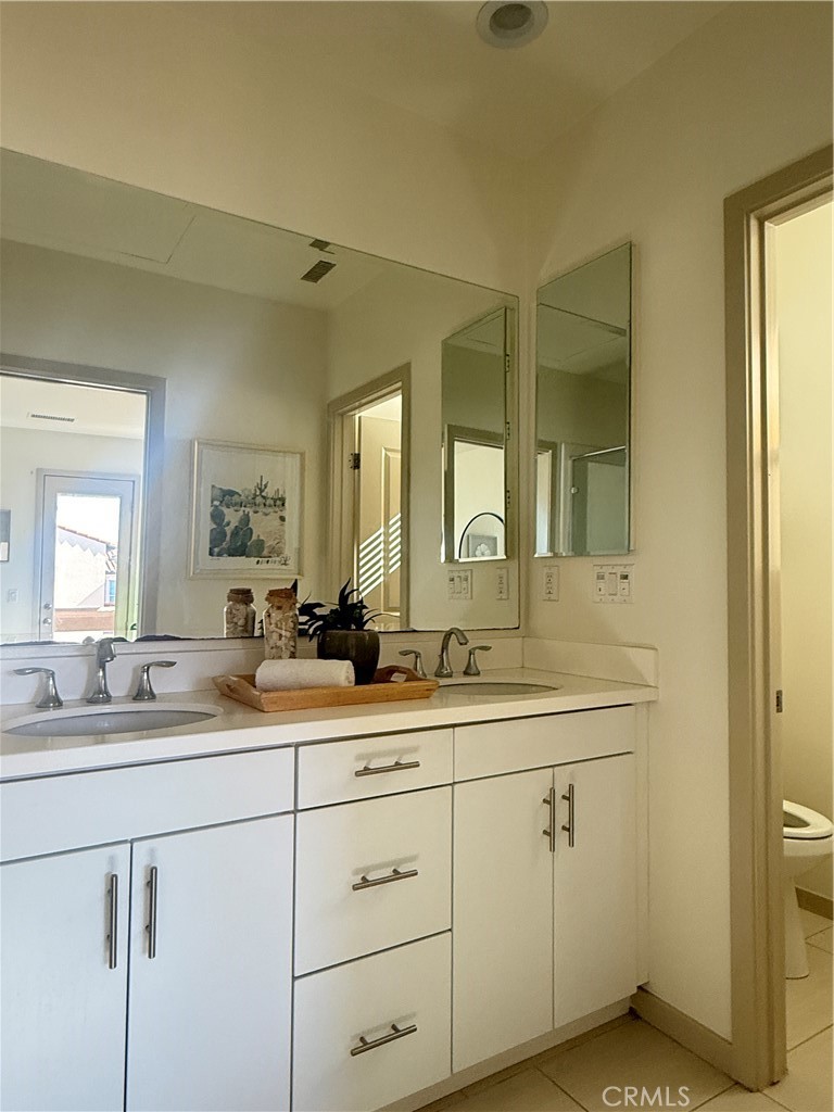 87 Evening Sun Irvine, CA 92620 - Photo 19 of 29 a bathroom with a double vanity sink mirror and