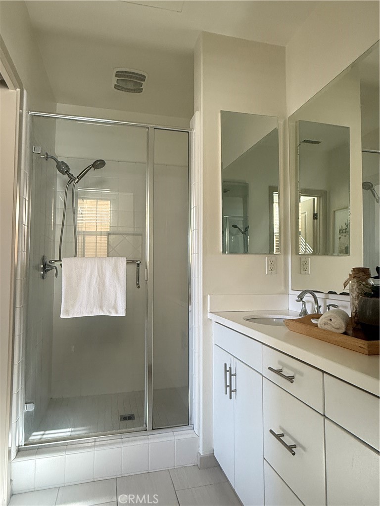 87 Evening Sun Irvine, CA 92620 - Photo 20 of 29 a bathroom with a shower sink and mirror