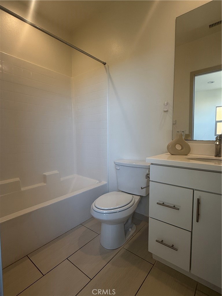 87 Evening Sun Irvine, CA 92620 - Photo 25 of 29 a bathroom with a sink a toilet and shower