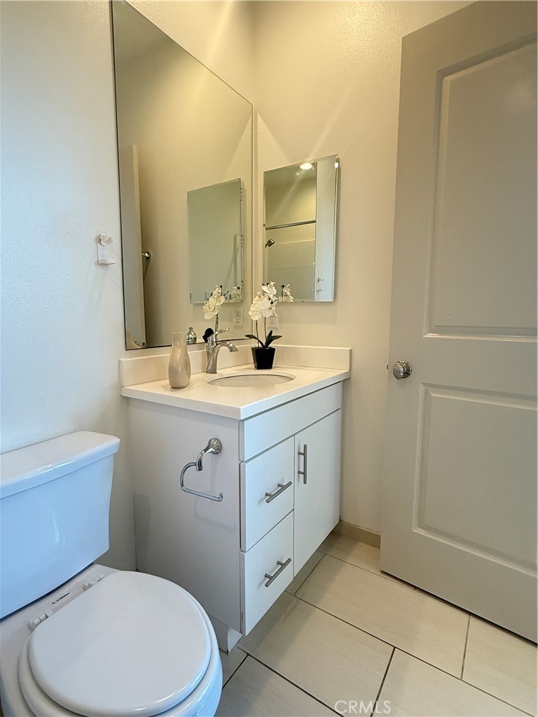 87 Evening Sun Irvine, CA 92620 - Photo 26 of 29 a bathroom with a toilet sink and mirror