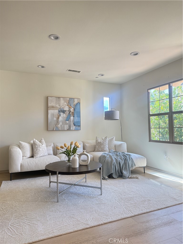 87 Evening Sun Irvine, CA 92620 - Photo 3 of 29 a living room with furniture and painting on the wall