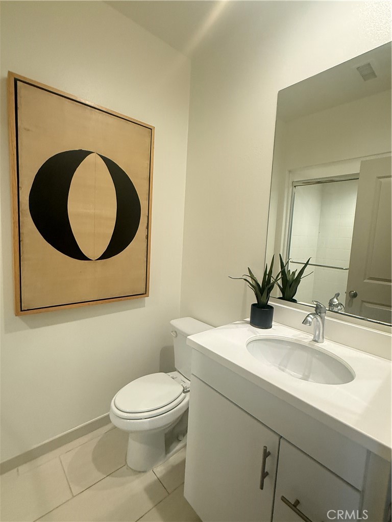 87 Evening Sun Irvine, CA 92620 - Photo 5 of 29 a bathroom with a toilet sink vanity and mirror