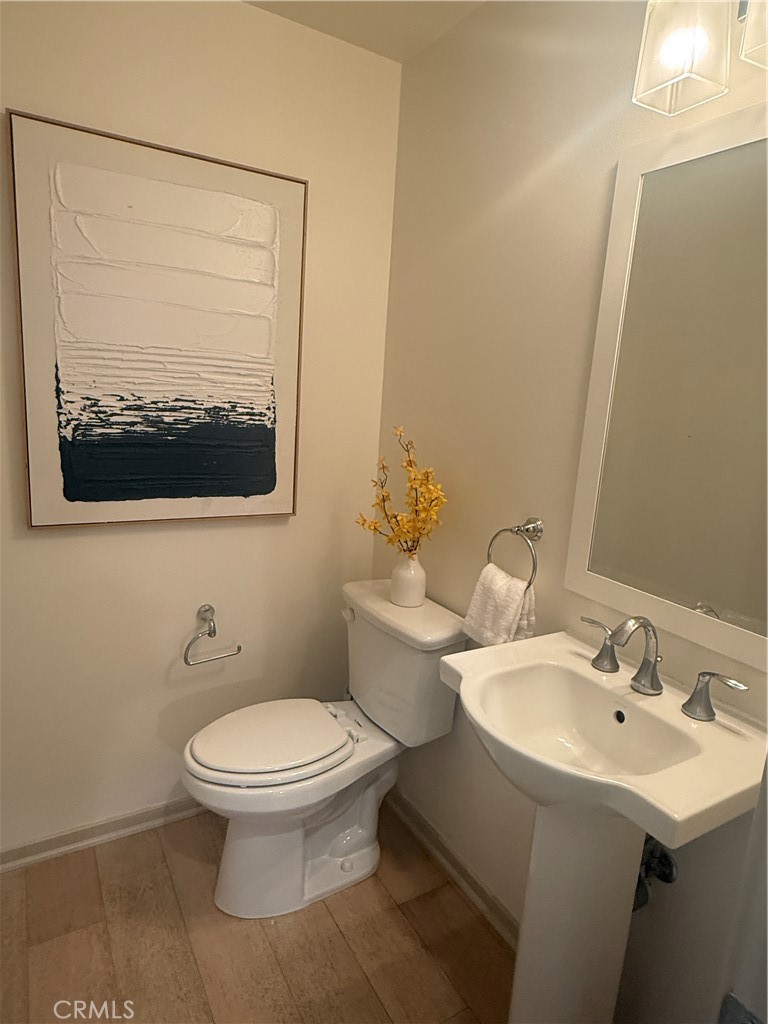 87 Evening Sun Irvine, CA 92620 - Photo 6 of 29 a bathroom with a toilet a sink and mirror
