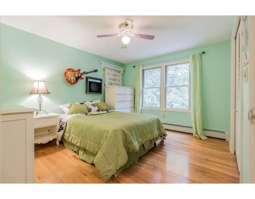 119 Rattlesnake Hill Road Andover, MA 01810 - Photo 20 of 30 a bedroom with a bed and a chandelier