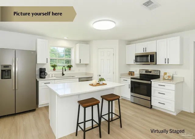 a kitchen with a stove a sink and a refrigerator