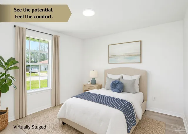 a bedroom with a bed and a painting on the wall