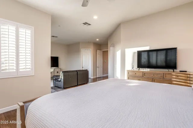 a bedroom with a bed and a lamp