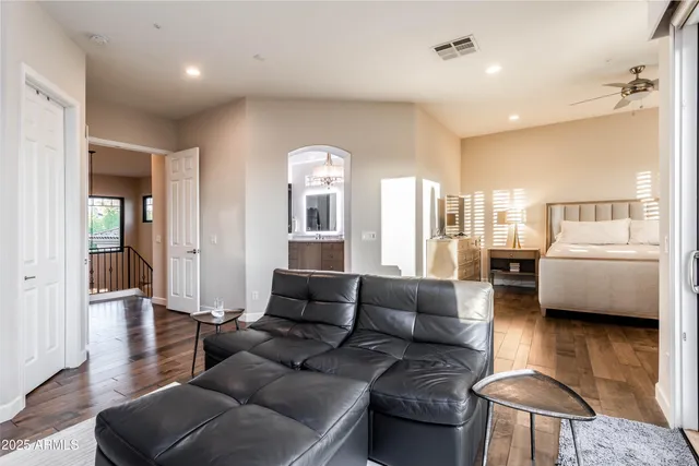 a living room with furniture a table and a large window