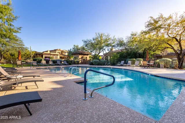 a view of a house with swimming pool and a garden