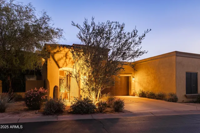 a view of a house with a flower garden