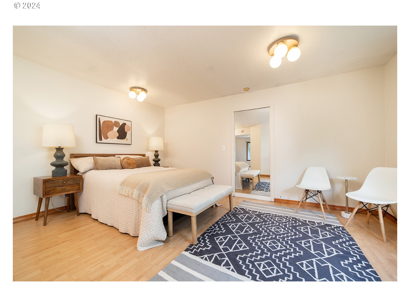 8767 Northwest Springville Road Portland, OR 97231 - Photo 12 of 47 a spacious bedroom with a bed and cabinets