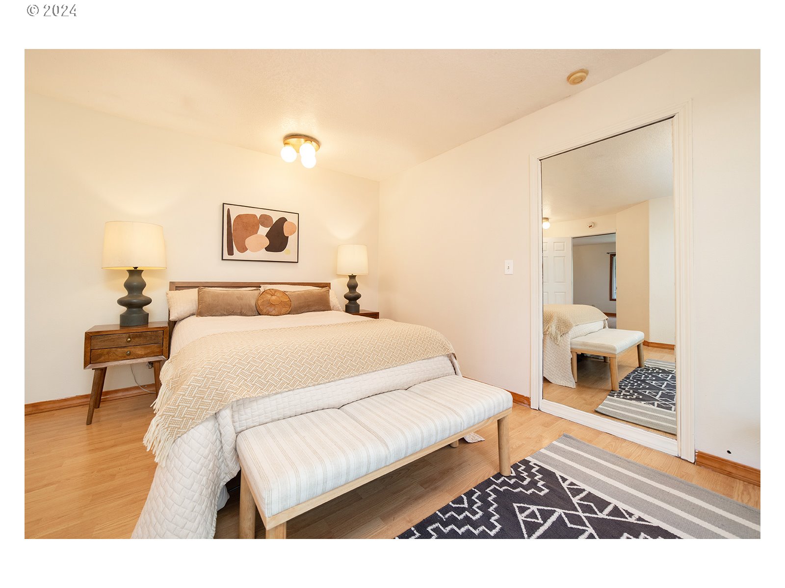 8767 Northwest Springville Road Portland, OR 97231 - Photo 14 of 47 a bedroom with a bed and a painting on the wall