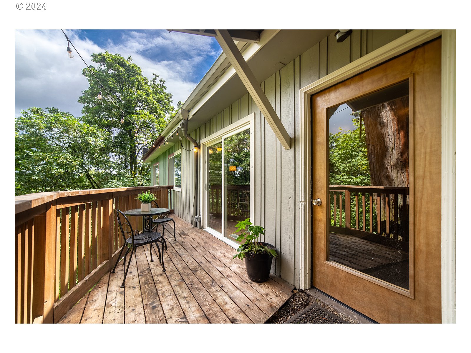 8767 Northwest Springville Road Portland, OR 97231 - Photo 20 of 47 a view of a house with backyard porch and sitting area