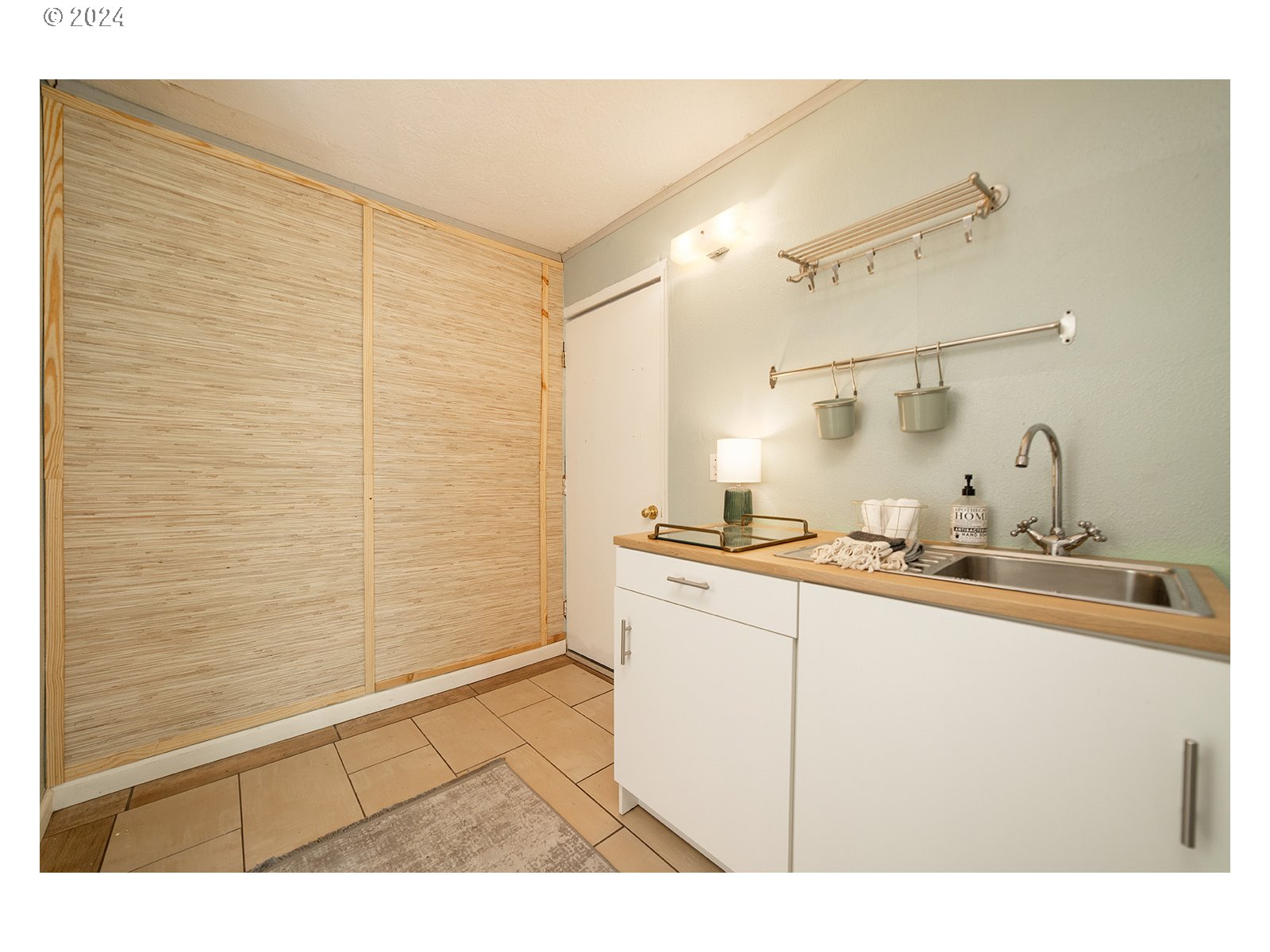 8767 Northwest Springville Road Portland, OR 97231 - Photo 26 of 47 a kitchen with a sink a stove and cabinets