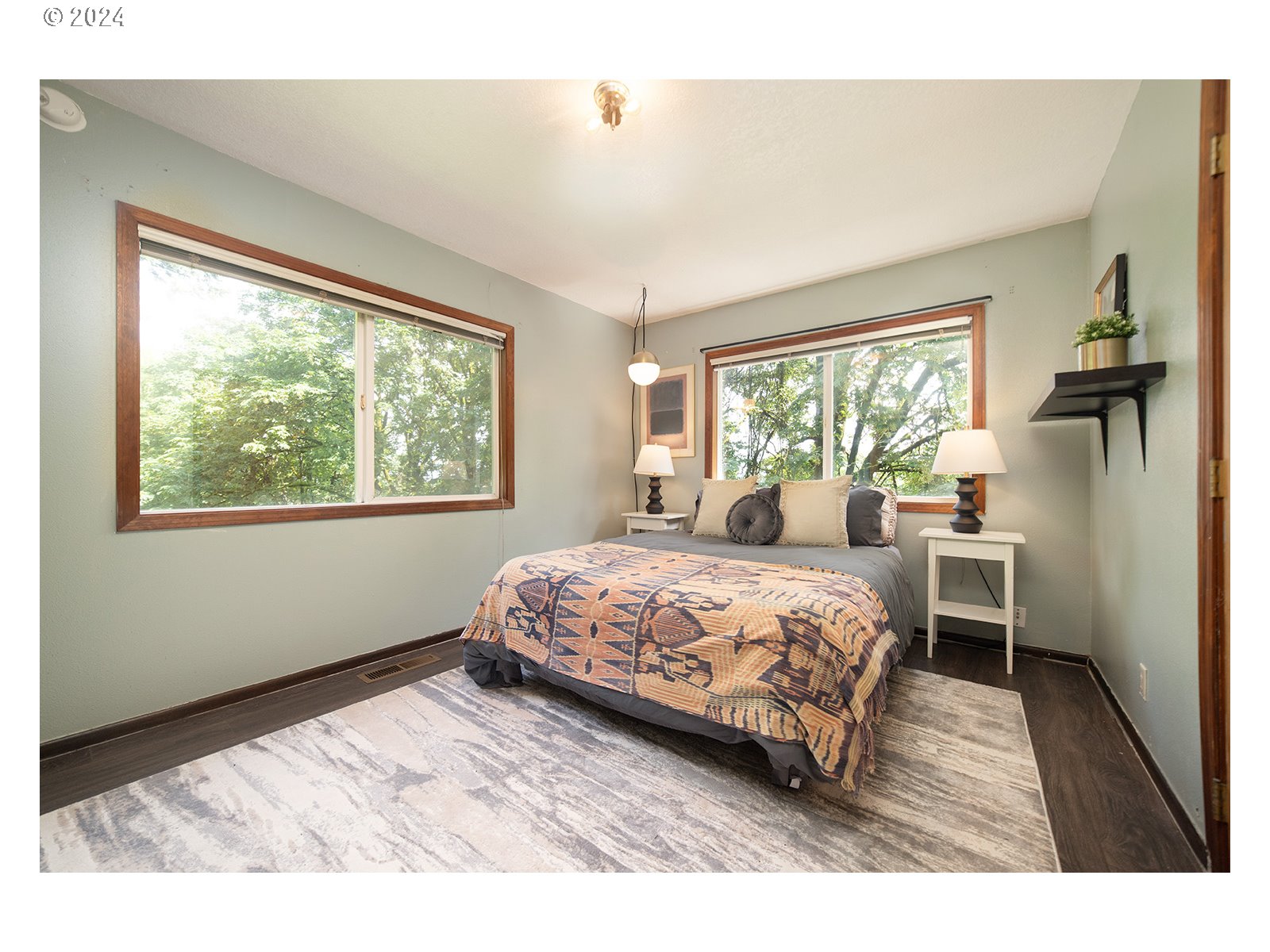 8767 Northwest Springville Road Portland, OR 97231 - Photo 29 of 47 a bedroom with a bed wooden floor and window