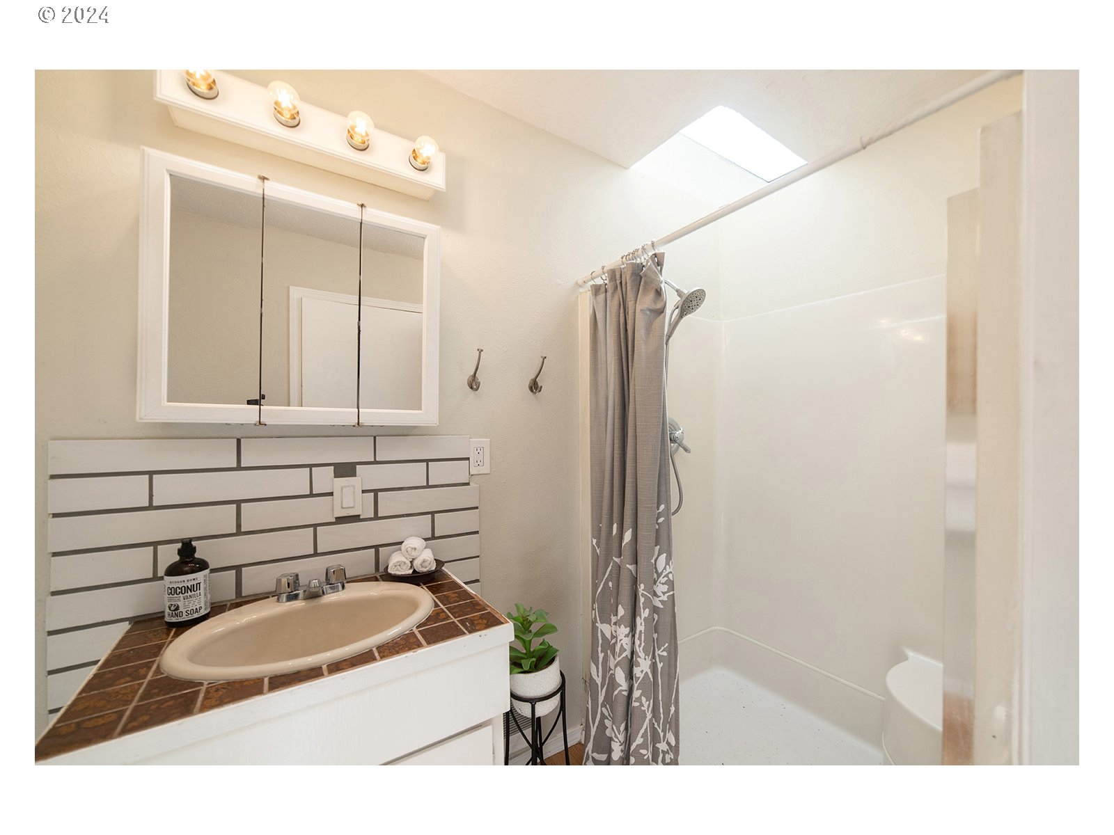 8767 Northwest Springville Road Portland, OR 97231 - Photo 31 of 47 a bathroom with a sink and a mirror