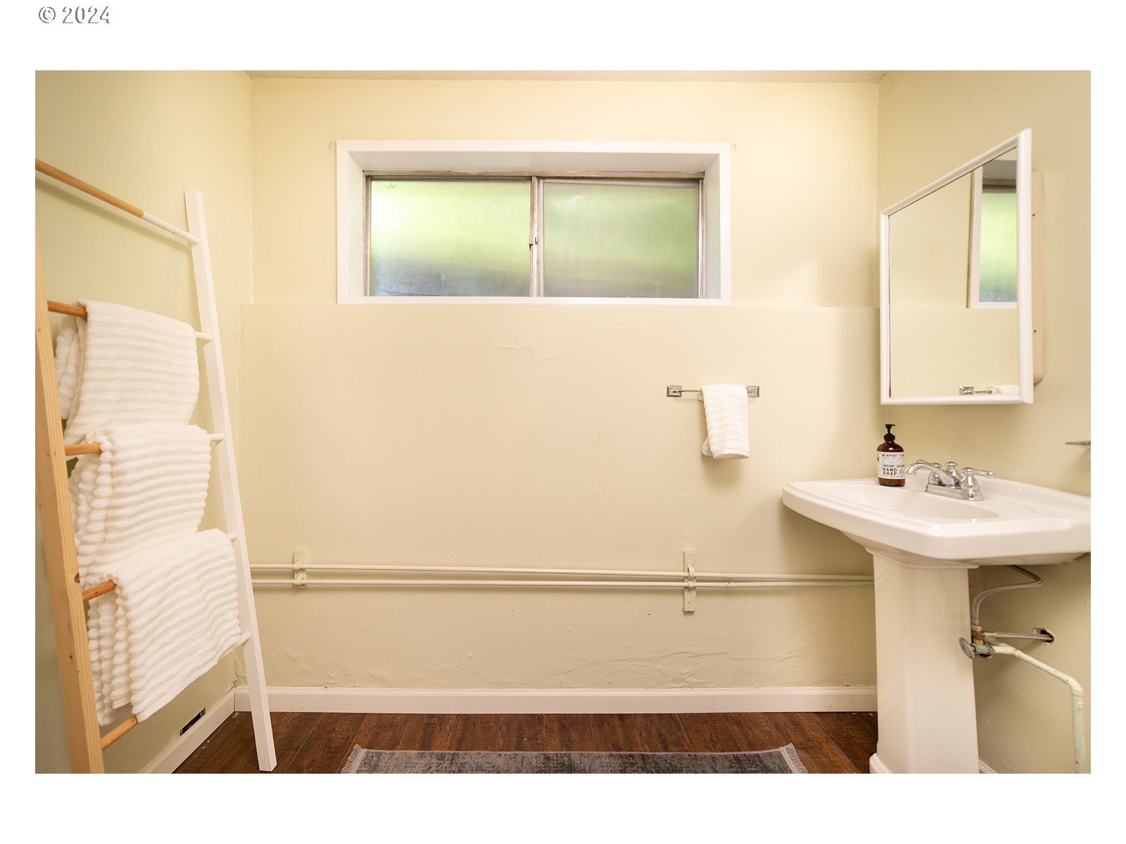 8767 Northwest Springville Road Portland, OR 97231 - Photo 35 of 47 a bathroom with a sink and a mirror
