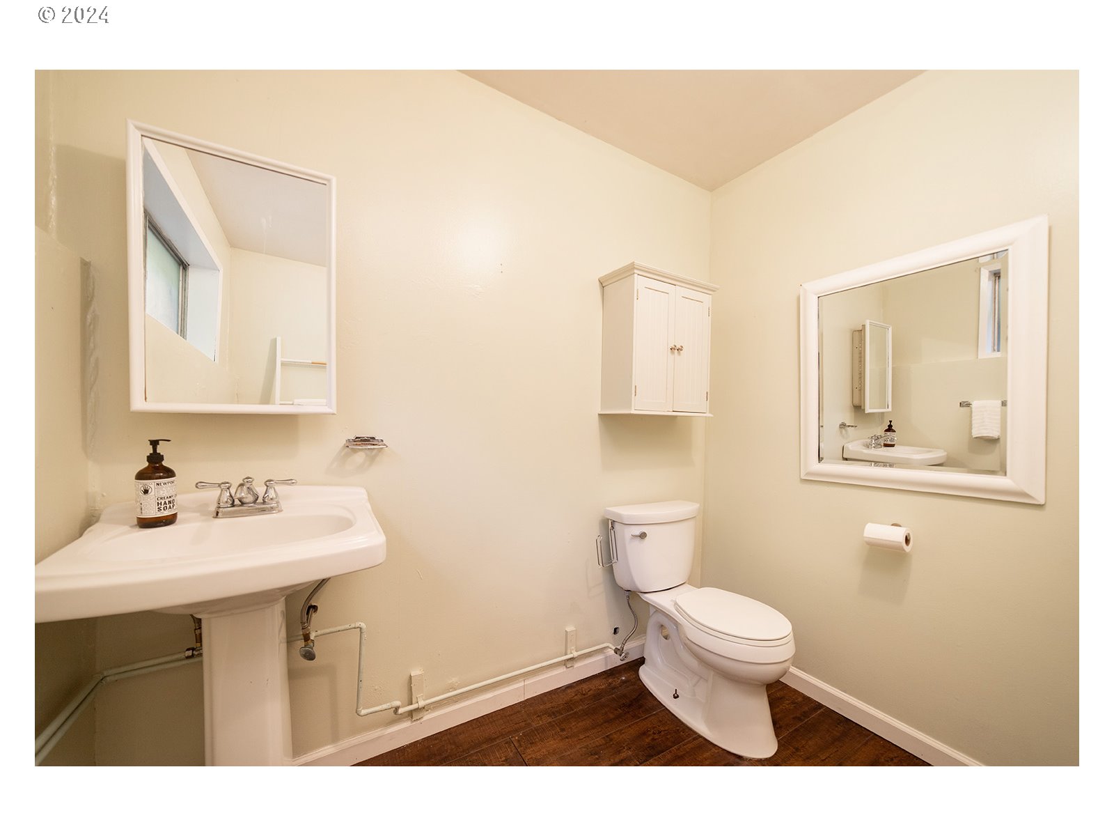 8767 Northwest Springville Road Portland, OR 97231 - Photo 36 of 47 a bathroom with a sink a toilet and mirror