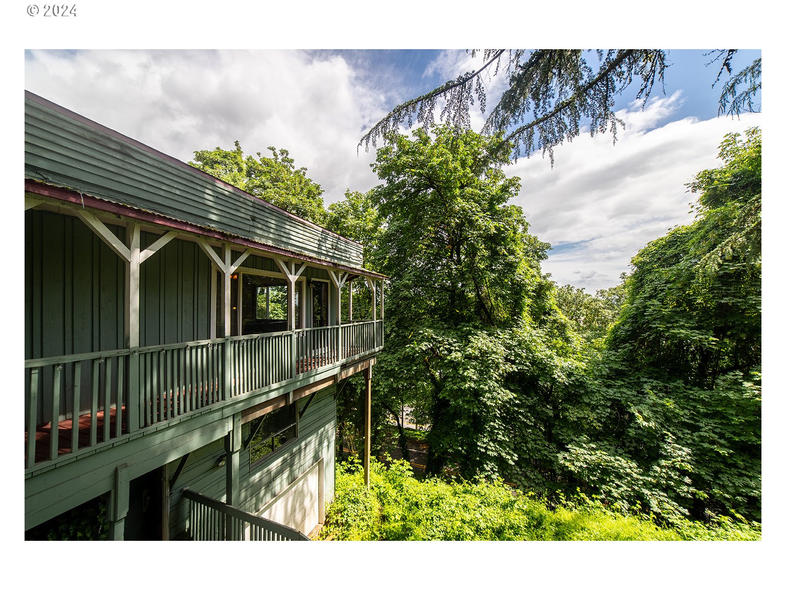 8767 Northwest Springville Road Portland, OR 97231 - Photo 38 of 47 a view of a house with a yard