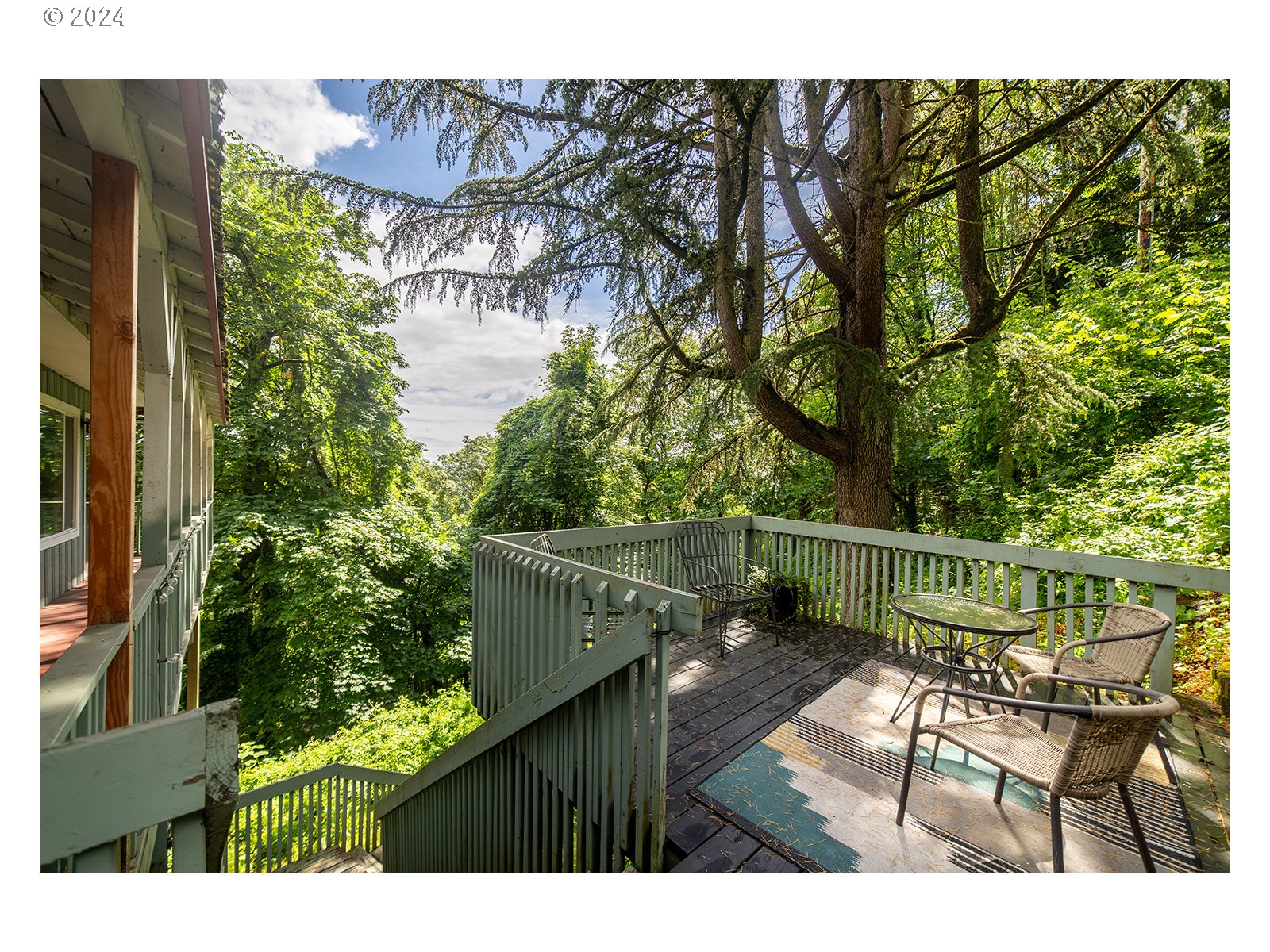 8767 Northwest Springville Road Portland, OR 97231 - Photo 40 of 47 a view of a balcony with chairs and wooden fence