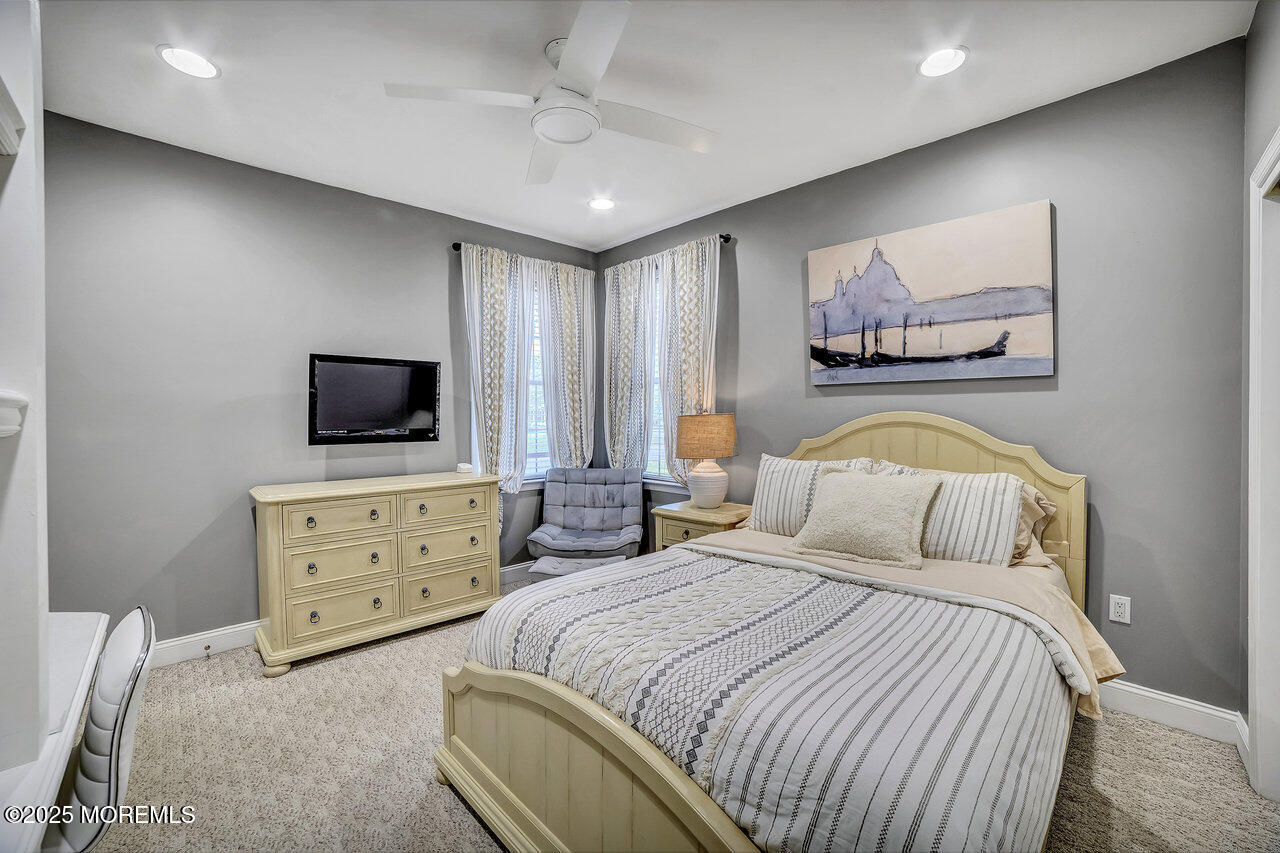 11 Victoria Court Cream Ridge, NJ 08514 - Photo 20 of 67 a bedroom with a bed and a flat screen tv