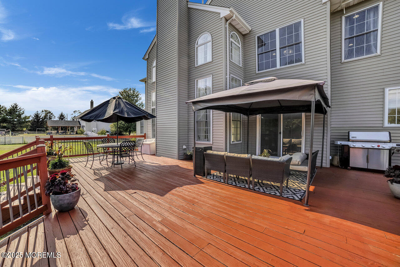 11 Victoria Court Cream Ridge, NJ 08514 - Photo 57 of 67 a view of roof deck with dining table and chairs with wooden floor and fence