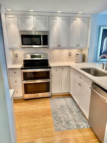 a kitchen with a sink and a stove top oven