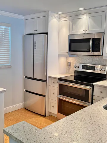 a kitchen with stainless steel appliances a stove a microwave and a refrigerator