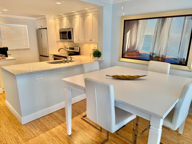 a kitchen with a sink cabinets and wooden floor