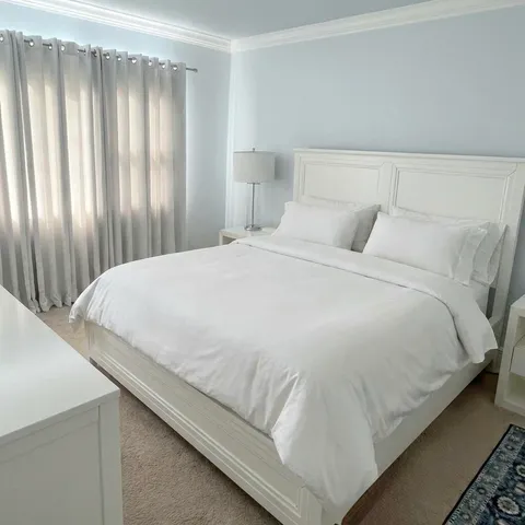 a bedroom with a bed and curtain