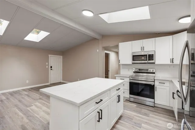 a kitchen with a stove a sink and a refrigerator