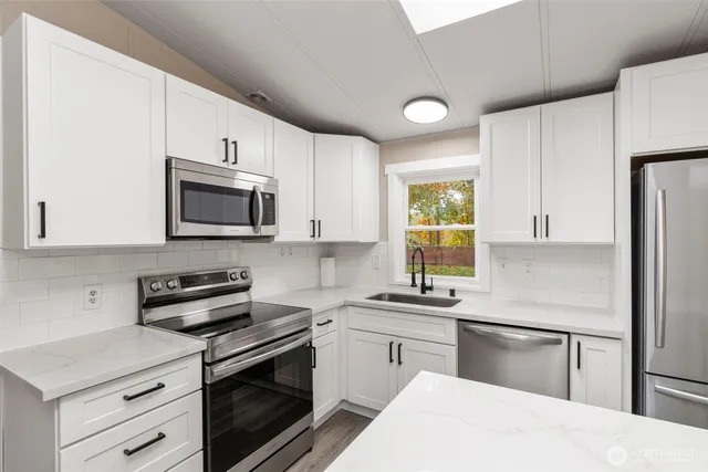 a kitchen with a refrigerator stove and microwave