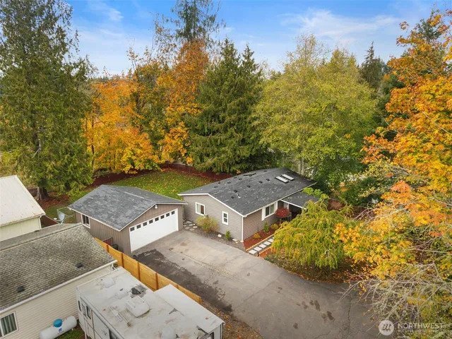 an aerial view of a house with a yard