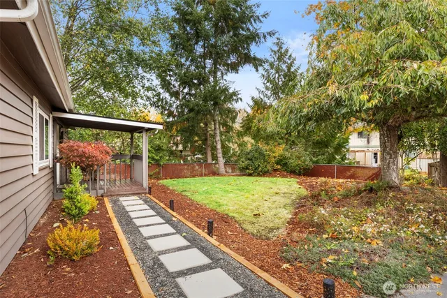 a view of a backyard with large trees