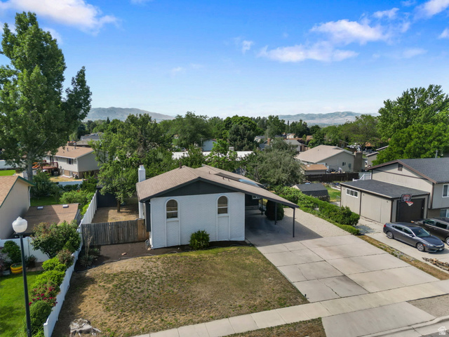 432 Calnette Drive Sandy, UT 84070 - Photo 31 of 48 Single-story residence featuring a carport, an expansive paved driveway, and an additional detached garage structure