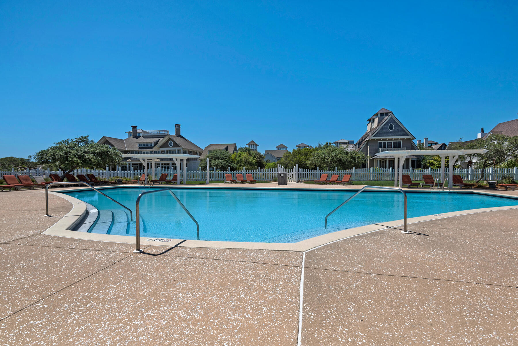 87 Salt Box Lane West Inlet Beach, FL 32461 - Photo 73 of 122 a view of a swimming pool with a bench and trees in the background