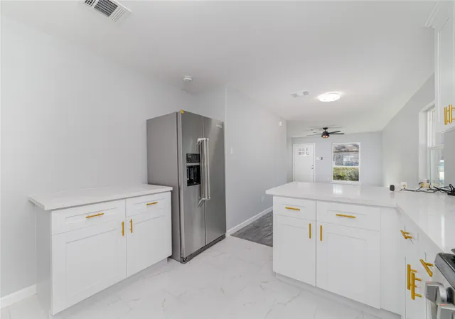 a view of a ceiling fan with wooden floor and a ceiling fan