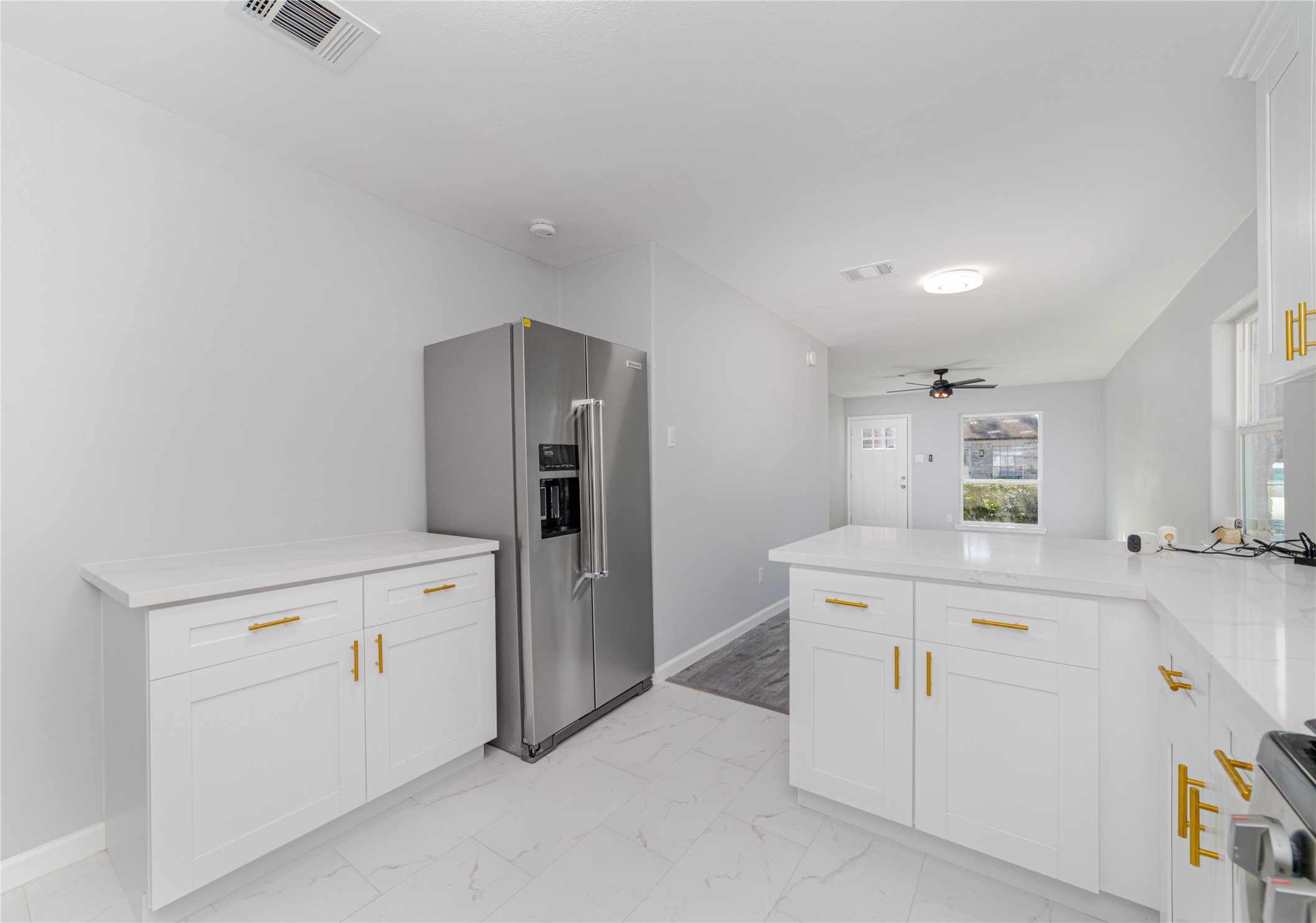 1716 Crestdale Drive, Unit 10 Houston, TX 77080 - Photo 13 of 21 a kitchen with white cabinets and refrigerator