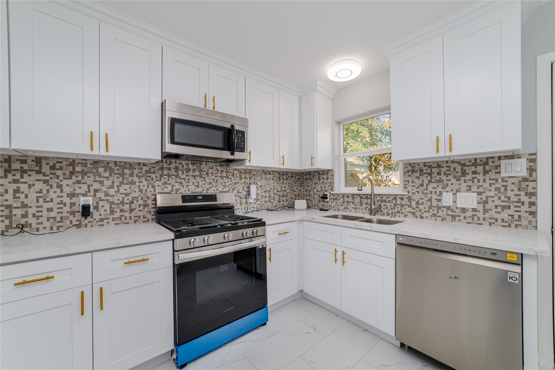 1716 Crestdale Drive, Unit 10 Houston, TX 77080 - Photo 14 of 21 a kitchen with granite countertop cabinets stainless steel appliances and a sink