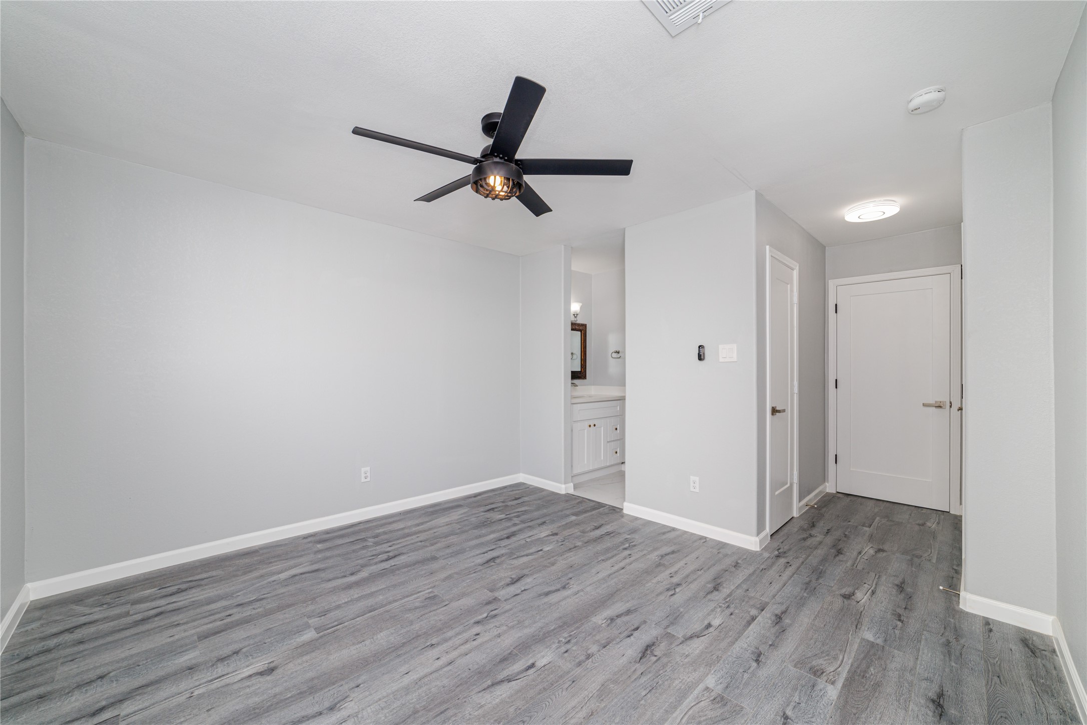 1716 Crestdale Drive, Unit 10 Houston, TX 77080 - Photo 16 of 21 a view of a room with wooden floor and ceiling fan
