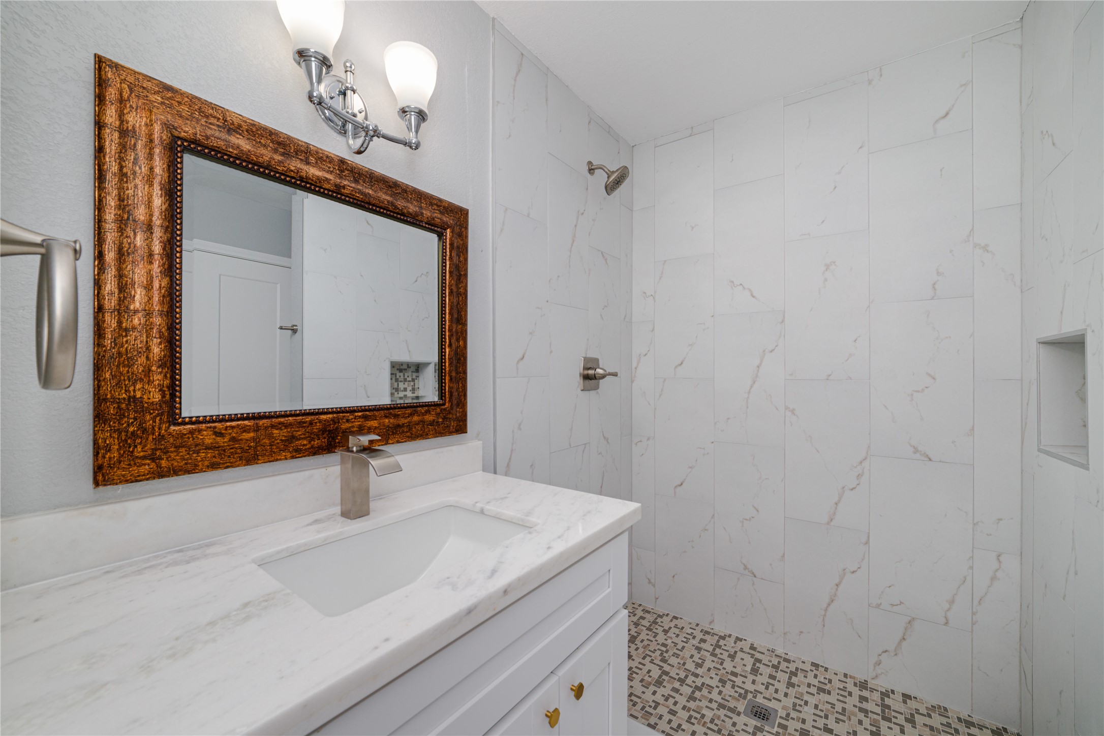 1716 Crestdale Drive, Unit 10 Houston, TX 77080 - Photo 18 of 21 a bathroom with a sink a mirror and vanity