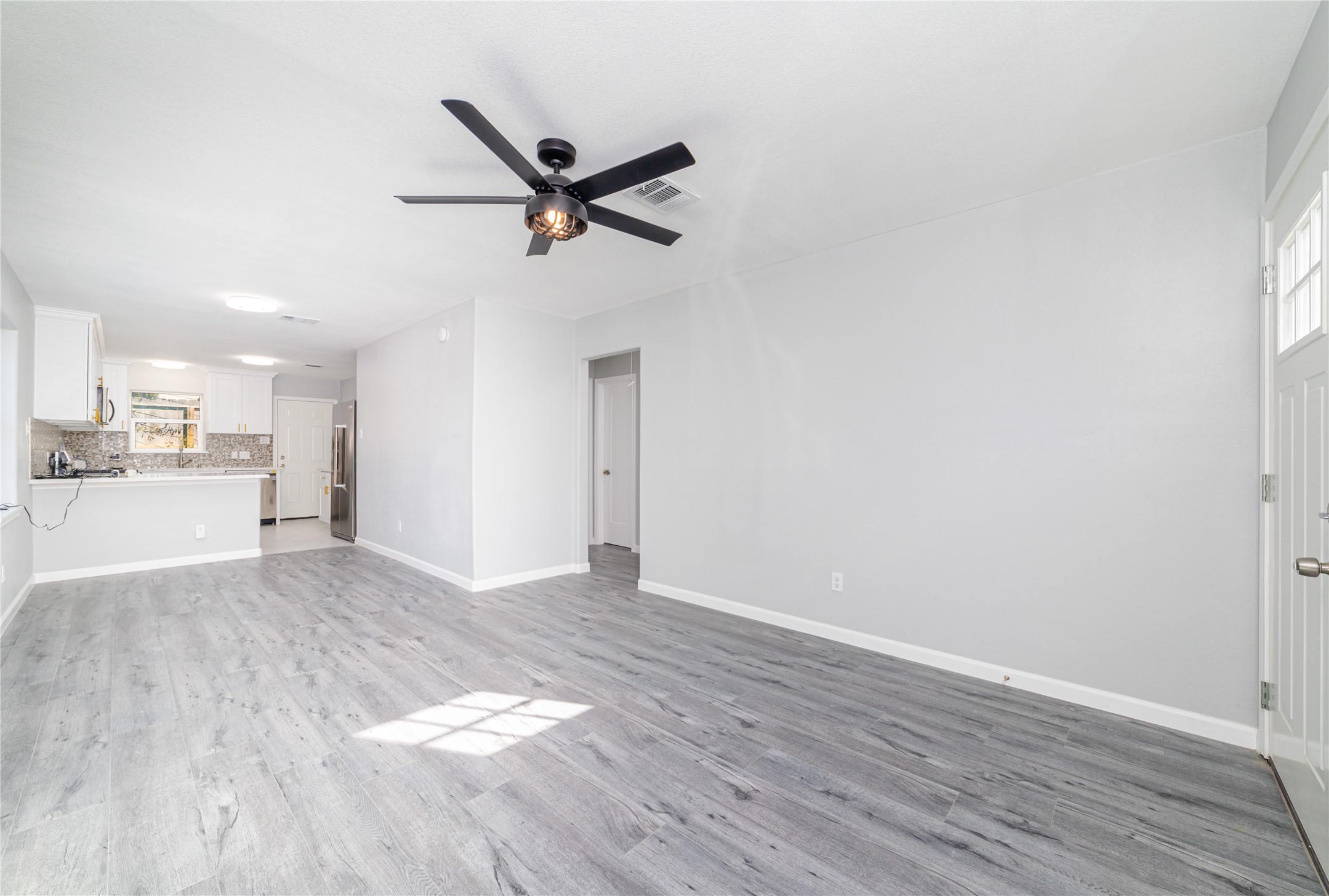 1716 Crestdale Drive, Unit 10 Houston, TX 77080 - Photo 7 of 21 a view of a kitchen with a sink and wooden floor