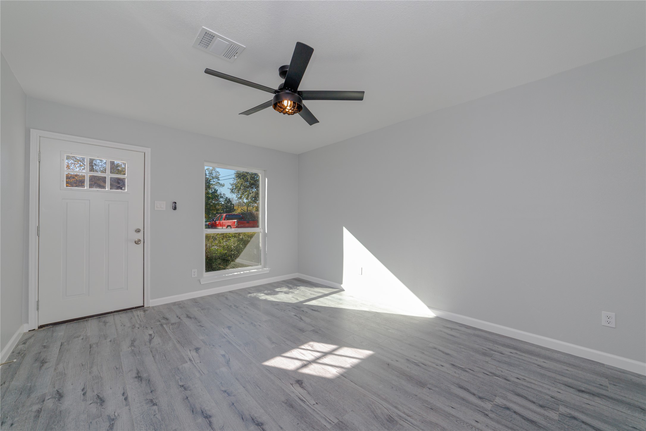 1716 Crestdale Drive, Unit 10 Houston, TX 77080 - Photo 8 of 21 a view of empty room with wooden floor and window