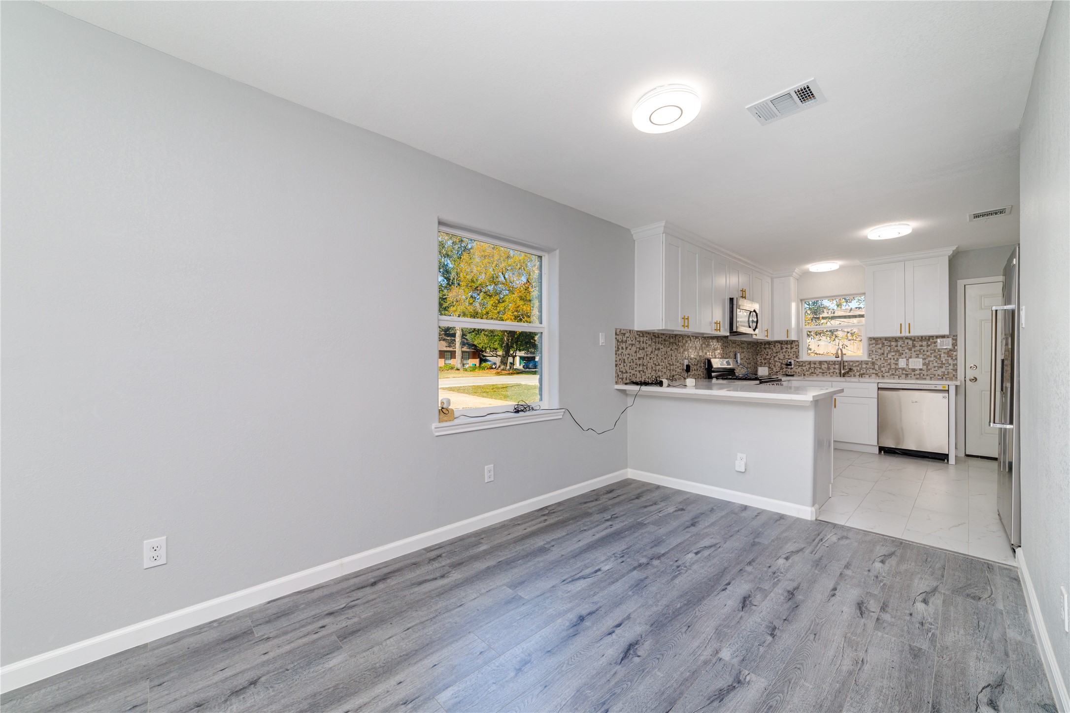 1716 Crestdale Drive, Unit 10 Houston, TX 77080 - Photo 9 of 21 a kitchen with a refrigerator and window