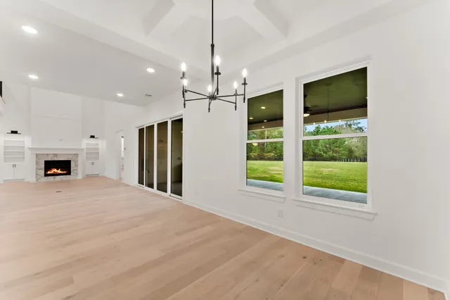 a view of an empty room with window and fire place