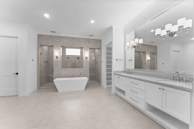a spacious bathroom with a large tub shower and sink