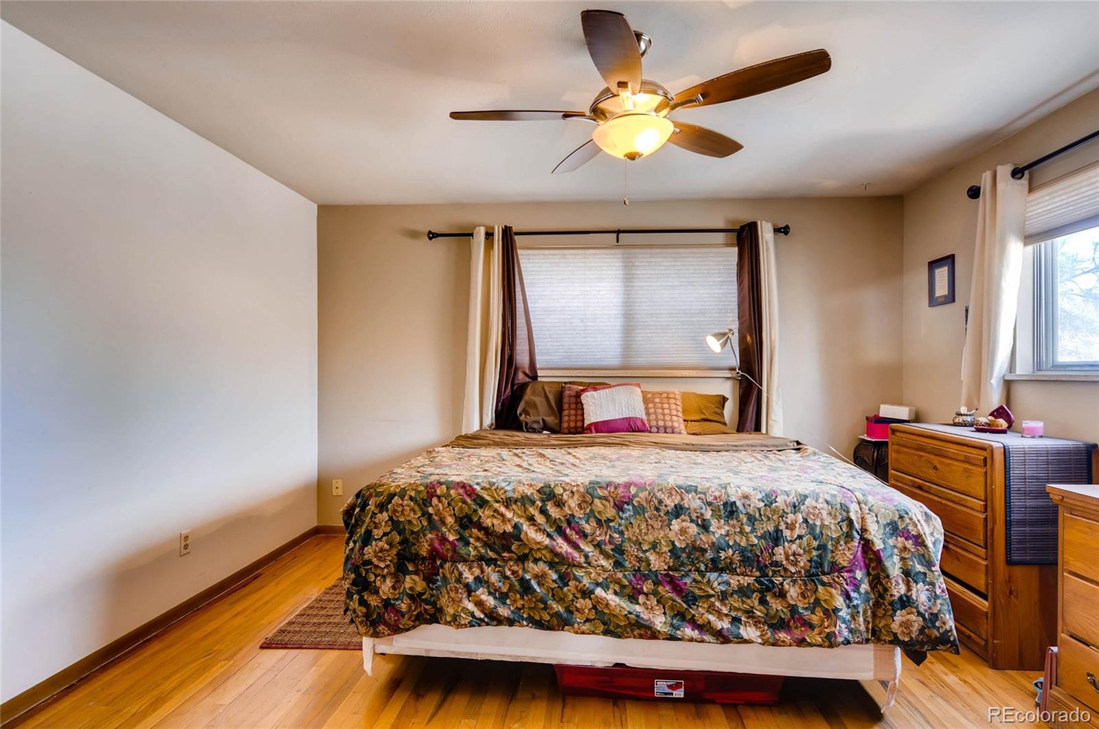 12475 West 38th Avenue Wheat Ridge, CO 80033 - Photo 11 of 22 a bedroom with a bed and a chandelier