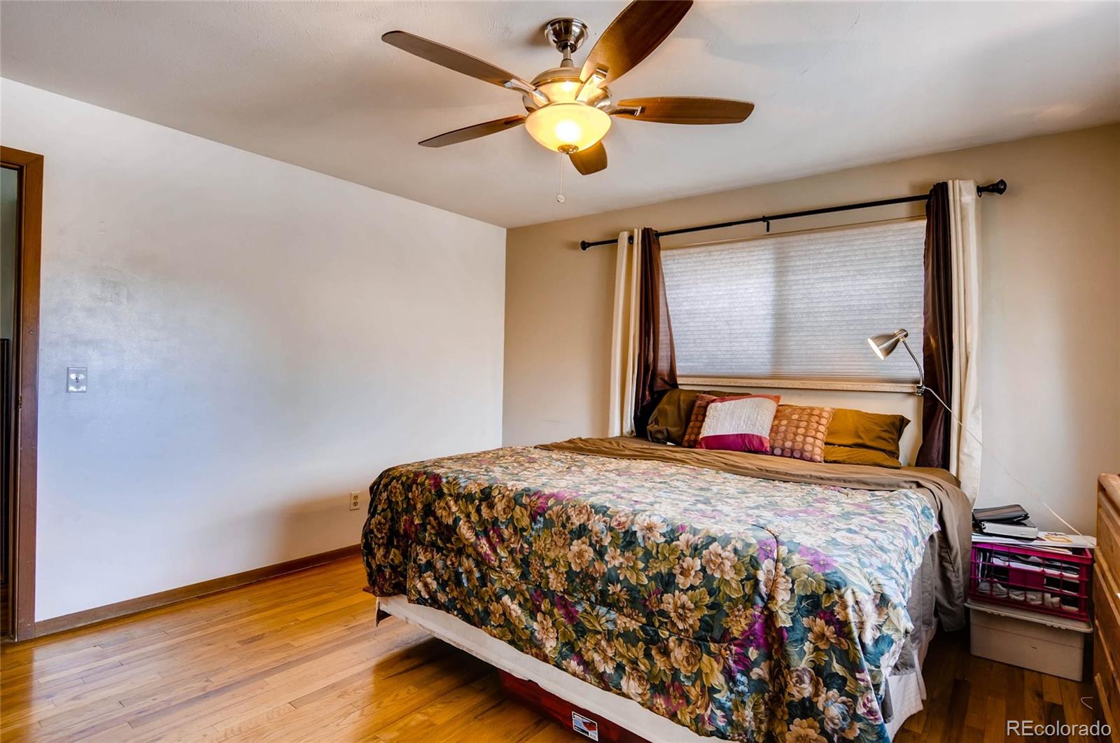 12475 West 38th Avenue Wheat Ridge, CO 80033 - Photo 12 of 22 a bedroom with a bed and a chandelier