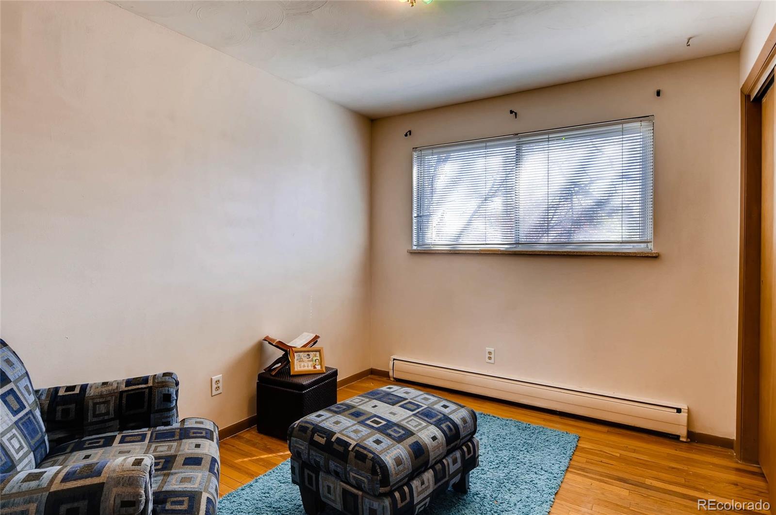 12475 West 38th Avenue Wheat Ridge, CO 80033 - Photo 14 of 22 a bedroom with furniture and a wooden floor